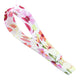 Side view of hannahPAD Drying Strap with a pink floral pattern, a handy, space-saving solution to dry your hannahPADs. Designed to snap your pad at the end of the drying strap, connect other pads and hang it to dry on your clothesline, doorknob or towel rack.