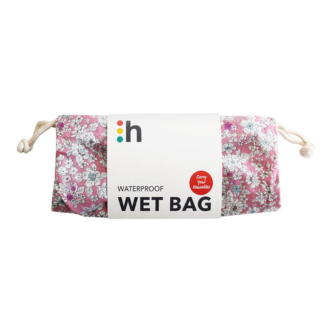 hannah Waterproof Wet Bag to keep your reusable cloth pads organised. Features 2 compartments to separate clean and used pads, a waterproof lining on the inside, and a secure drawstring closure. Pink floral design.