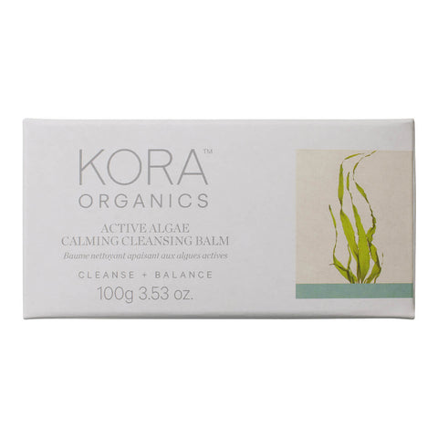 100g box of KORA Organics Active Algae Calming Cleansing Balm, a cleanser with microalgae, pineapple enzymes, jojoba and squalane that cleanses away makeup, dirt and oil for a clearer, more balanced complexion. Packaged in a white box with an illustration of algae on the front.