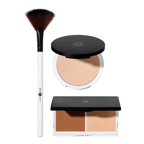 Lily Lolo Luminous Glow Collection makeup gift set including Pressed Finishing Powder, Sculpt & Gow Contour Duo, and Small Fan Brush.