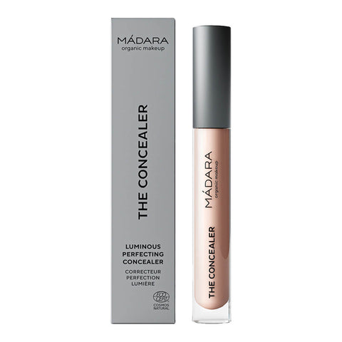 Madara The Concealer in shade Latte #25, a naturally certified concealer that hides dark circles, blemishes, and redness with a dewy finish. It offers long-lasting comfort and contains hydrating hyaluronic acid and retouching minerals. Packaged in a slim, cylindrical tube with a twist-off cap and a built-in applicator, featuring the brand name on the label.