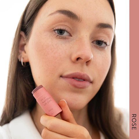 Model wearing Winki Zinc's Tinted Lip Zinc in the shade, Rose, a beautiful, neutral brown/pink (medium pigment). Tinted Lip Zinc is a mineral-based lip balm designed to heal and protect your lips from the sun while adding a hint of natural colour.