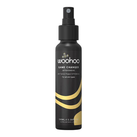 100ml spray bottle of Woohoo Game Changer Aftershave, designed to calm and restore balance, promoting smooth and refreshed skin while preventing post-shave redness and irritation. The formula hydrates and repairs skin, featuring a pleasant scent as an added bonus. Packaged in a black aluminium bottle with a spray pump.